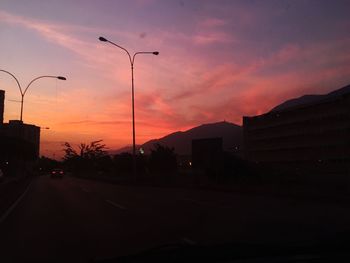 Street against sky at sunset