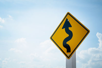 Low angle view of road sign against sky