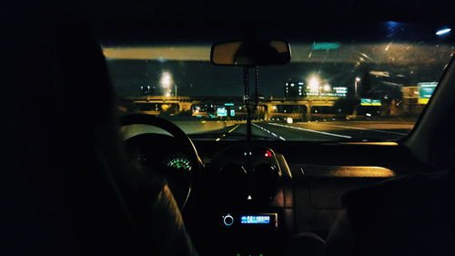 Close-up of illuminated car on road at night