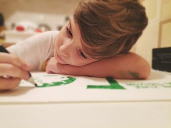 Portrait of boy on table