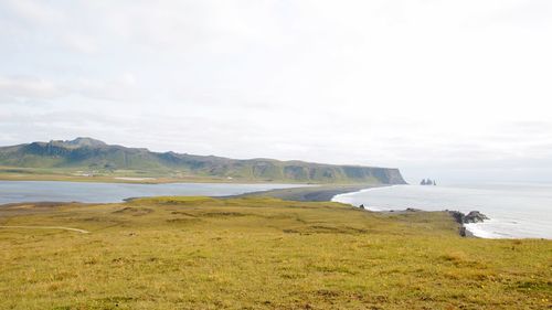 Scenic view of sea and mountains against sky