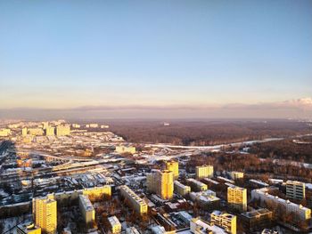 High angle view of buildings in city during sunset