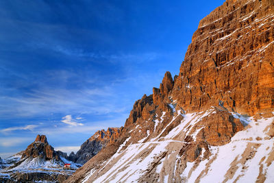 Low angle view of rocky mountain against sky