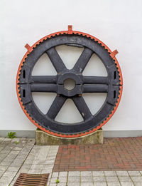 Close-up of bicycle wheel against wall