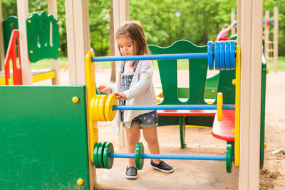 Full length of woman playing on slide at playground