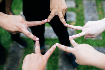 Cropped image of people hands against blurred background