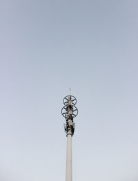 Low angle view of communications tower against sky