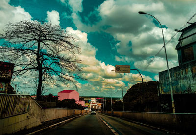 Road by city against sky