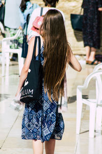 Rear view of woman standing in city