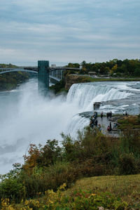 Scenic view of waterfall against sky