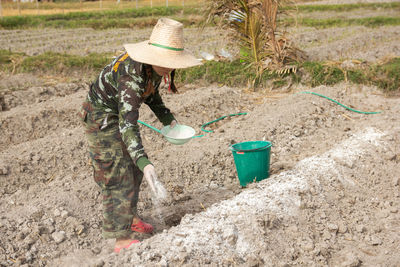 Side view of person working in farm