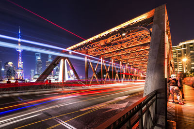 Illuminated bridge at night