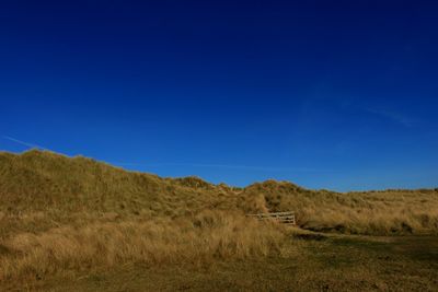Scenic view of landscape against clear blue sky