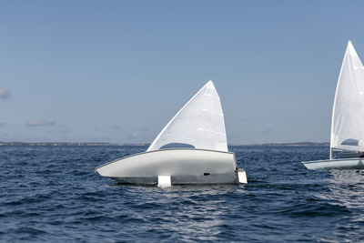 Sailboat sailing in sea against clear sky