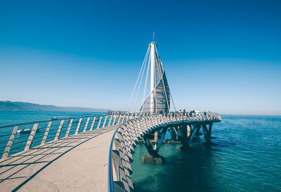 Golden gate bridge over sea against blue sky