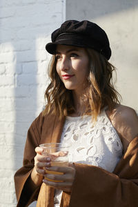 Beautiful young woman drinking glass