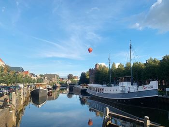 Reflection of buildings in river against sky