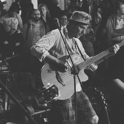 People playing guitar at music concert