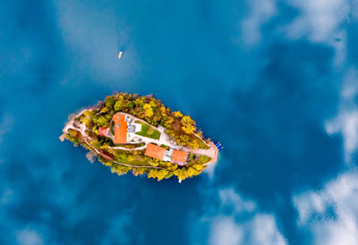 Digital composite image of old building by swimming pool against sky