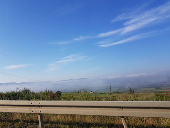 Scenic view of field against blue sky