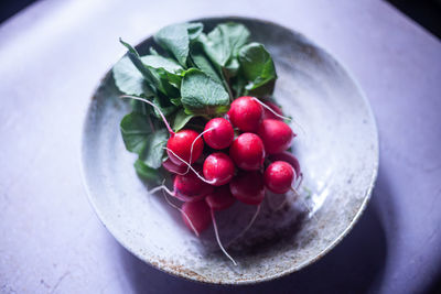 High angle view of strawberries in bowl on table