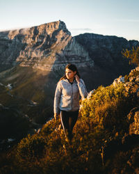 Full length of man standing on rock against mountain