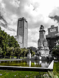 Low angle view of buildings against cloudy sky