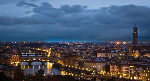 Illuminated cityscape against sky at night