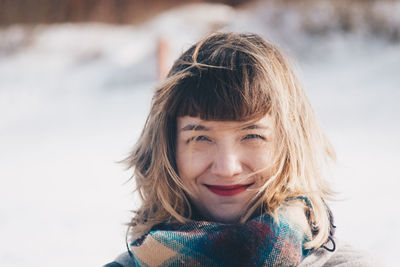 Close-up portrait of smiling young woman