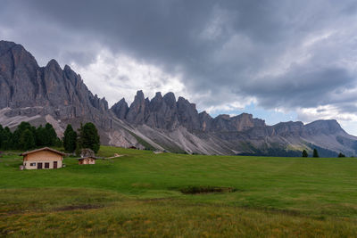 Scenic view of field and mountains against sky