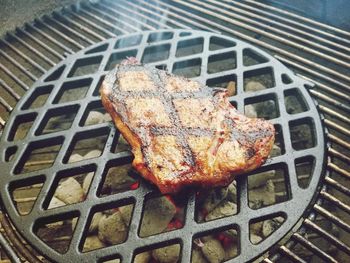 High angle view of meat on barbecue grill