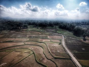 Scenic view of agricultural field against sky