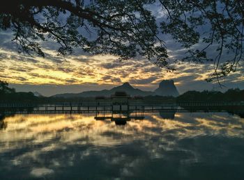 Tranquil view of lake at sunset