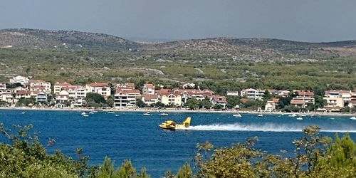 Scenic view of sea and buildings in city