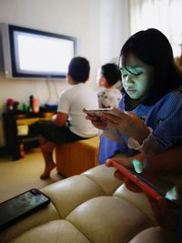 Girl using smart phone at home