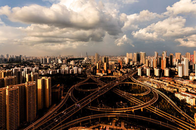 High angle view of cityscape against cloudy sky