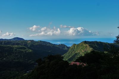 Scenic view of mountains and sea against sky