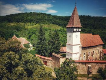 Panoramic view of trees and buildings against sky