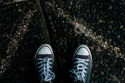 Close-up of shoes on gravels