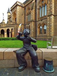 Statue against old building