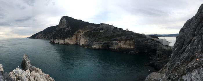 Panoramic view of sea and mountains against sky