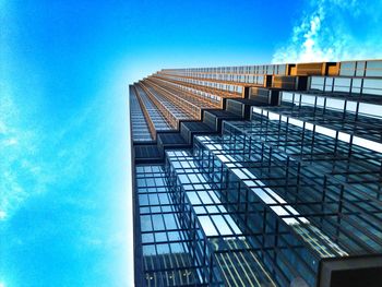 Low angle view of modern building against blue sky