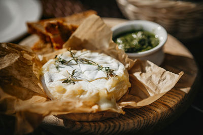 Oven baked camembert cheese with rosemary and pesto sauce