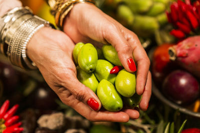 Close-up of hand holding tomatoes