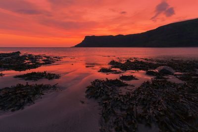 Scenic view of sea against orange sky
