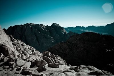 Scenic view of mountains against blue sky