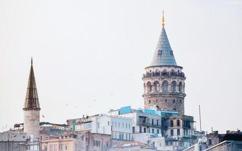 Tower of buildings in city against clear sky