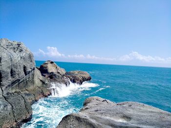 Scenic view of sea against blue sky