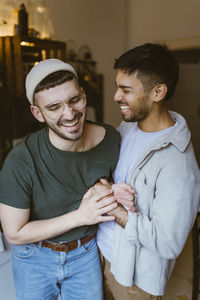 Happy gay couple enjoying with each other at home