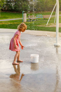 Rear view of woman standing in water